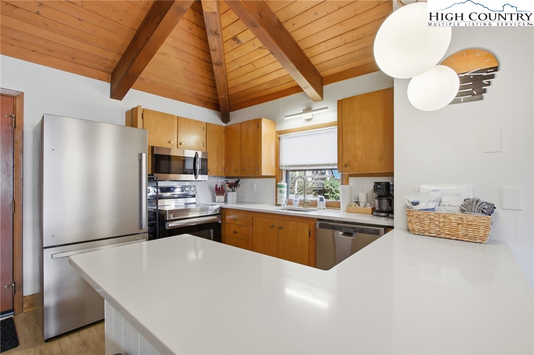 154 Lady Slipper Loop Newland, NC 28657 - Photo 13 of 50 a kitchen with stainless steel appliances granite countertop a sink a stove and refrigerator