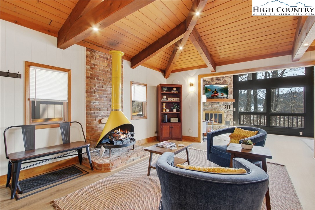 154 Lady Slipper Loop Newland, NC 28657 - Photo 15 of 50 a living room with furniture and floor to ceiling windows