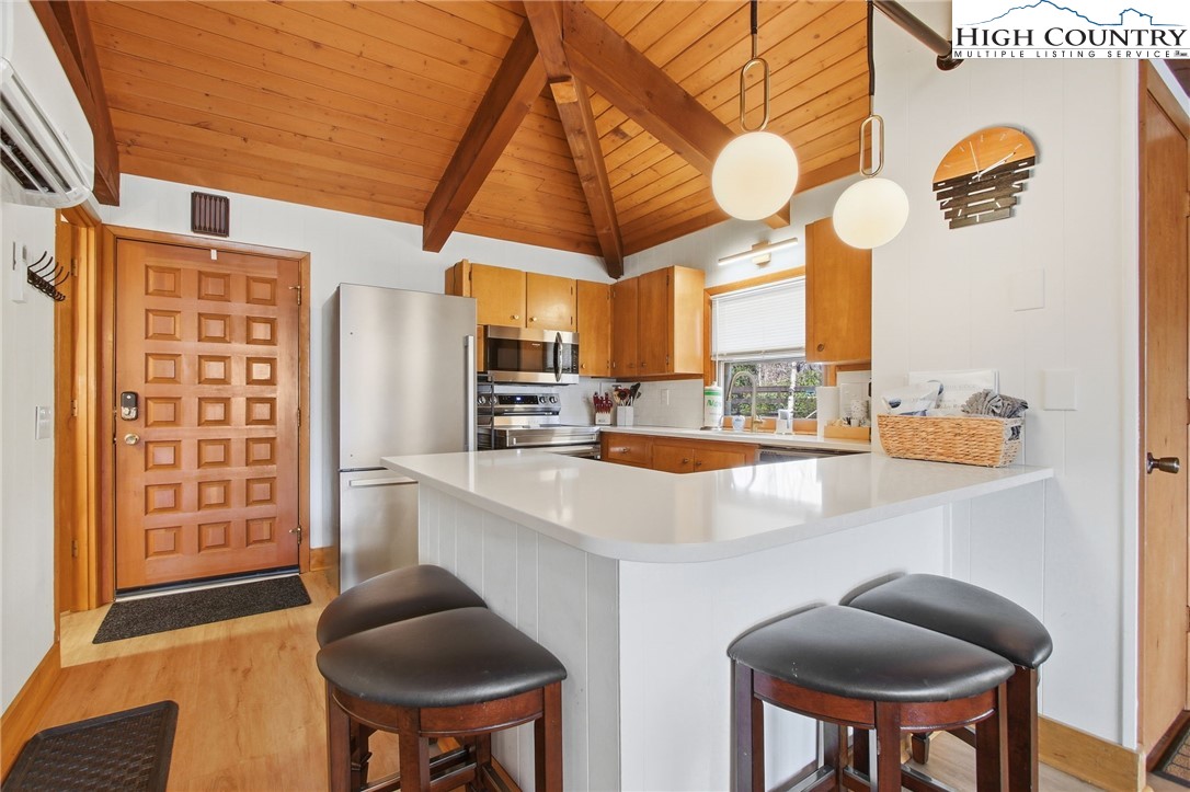154 Lady Slipper Loop Newland, NC 28657 - Photo 17 of 50 a kitchen with stainless steel appliances granite countertop a sink and a refrigerator