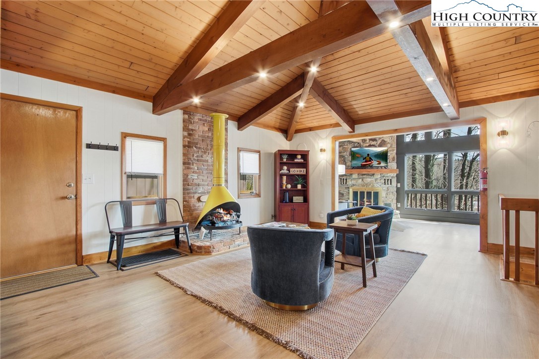 154 Lady Slipper Loop Newland, NC 28657 - Photo 18 of 50 a living room with furniture a wooden floor and next to a window