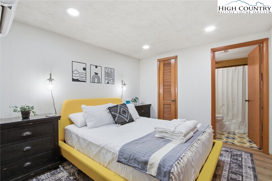 154 Lady Slipper Loop Newland, NC 28657 - Photo 20 of 50 a bedroom with a bed and painting on the wall