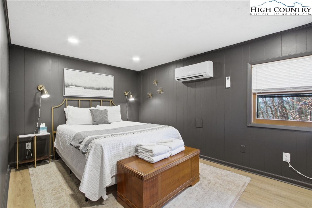 154 Lady Slipper Loop Newland, NC 28657 - Photo 24 of 50 a bedroom with a bed and a night stand