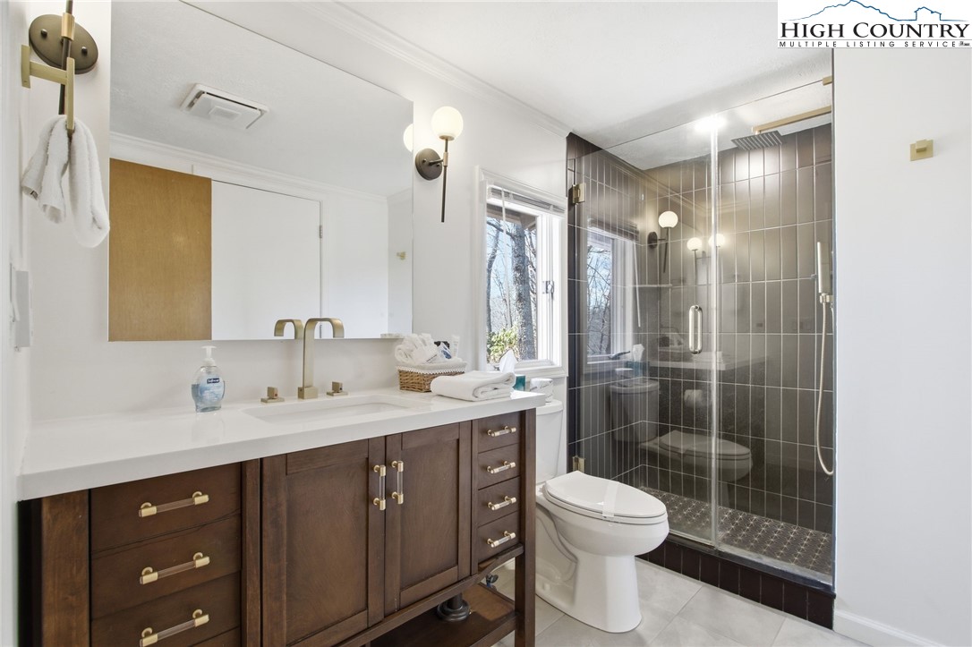 154 Lady Slipper Loop Newland, NC 28657 - Photo 25 of 50 a bathroom with a double vanity sink toilet and shower