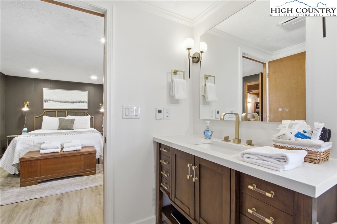 154 Lady Slipper Loop Newland, NC 28657 - Photo 26 of 50 a en suite bathroom with a double vanity sink and a mirror