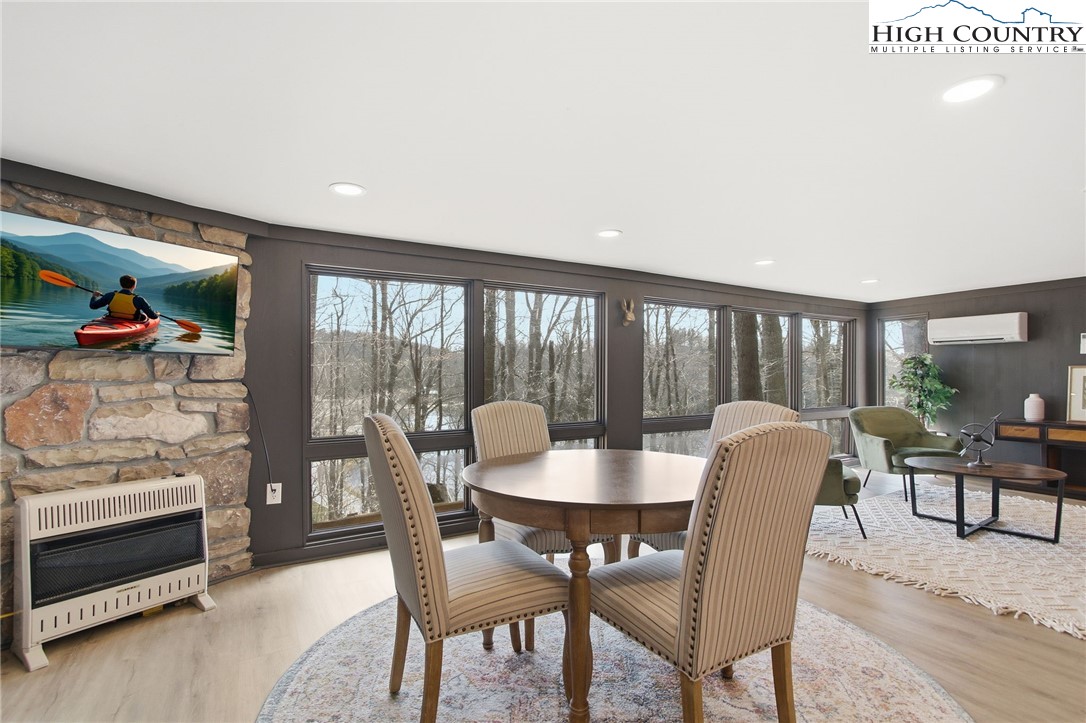 154 Lady Slipper Loop Newland, NC 28657 - Photo 34 of 50 a dining room with furniture wooden floor and a rug