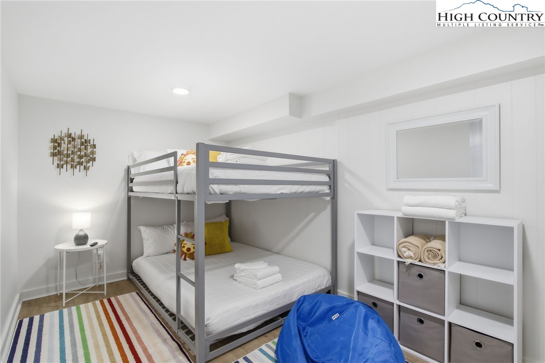 154 Lady Slipper Loop Newland, NC 28657 - Photo 38 of 50 a bedroom with a bunk bed and a lamp on the dresser