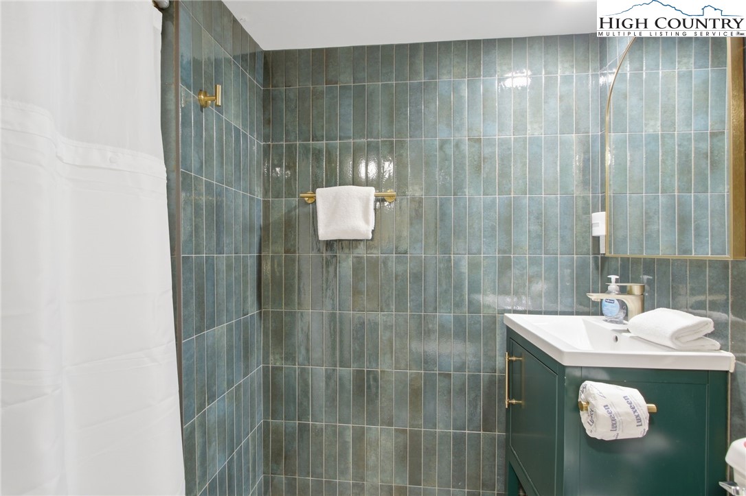 154 Lady Slipper Loop Newland, NC 28657 - Photo 39 of 50 a bathroom with a sink and mirror