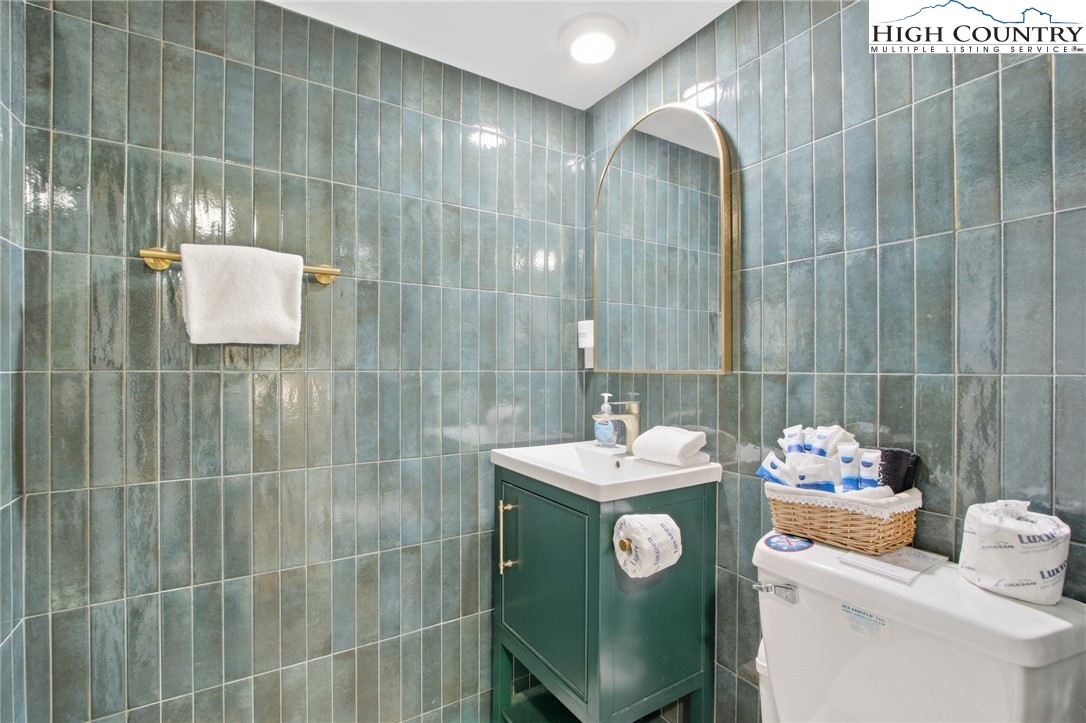 154 Lady Slipper Loop Newland, NC 28657 - Photo 40 of 50 a bathroom with a sink mirror and toilet