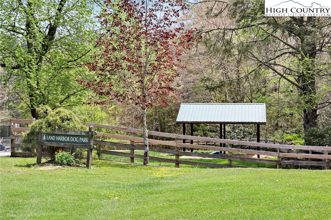154 Lady Slipper Loop Newland, NC 28657 - Photo 47 of 50 a view of a swimming pool with lawn chairs and a big yard