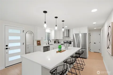 a large kitchen with a table and chairs