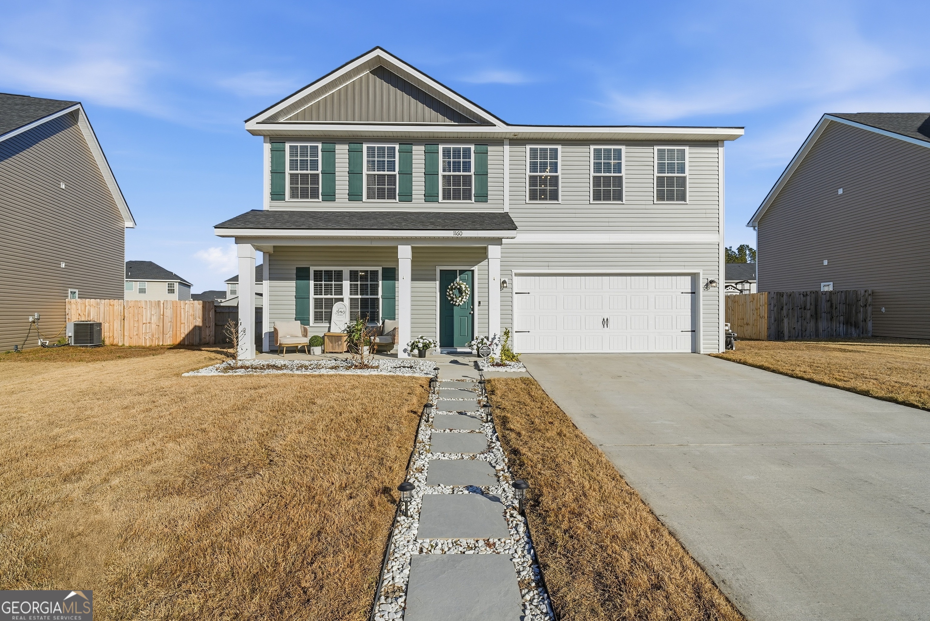 a view of a house with flat outdoor space and a car parked in front of it