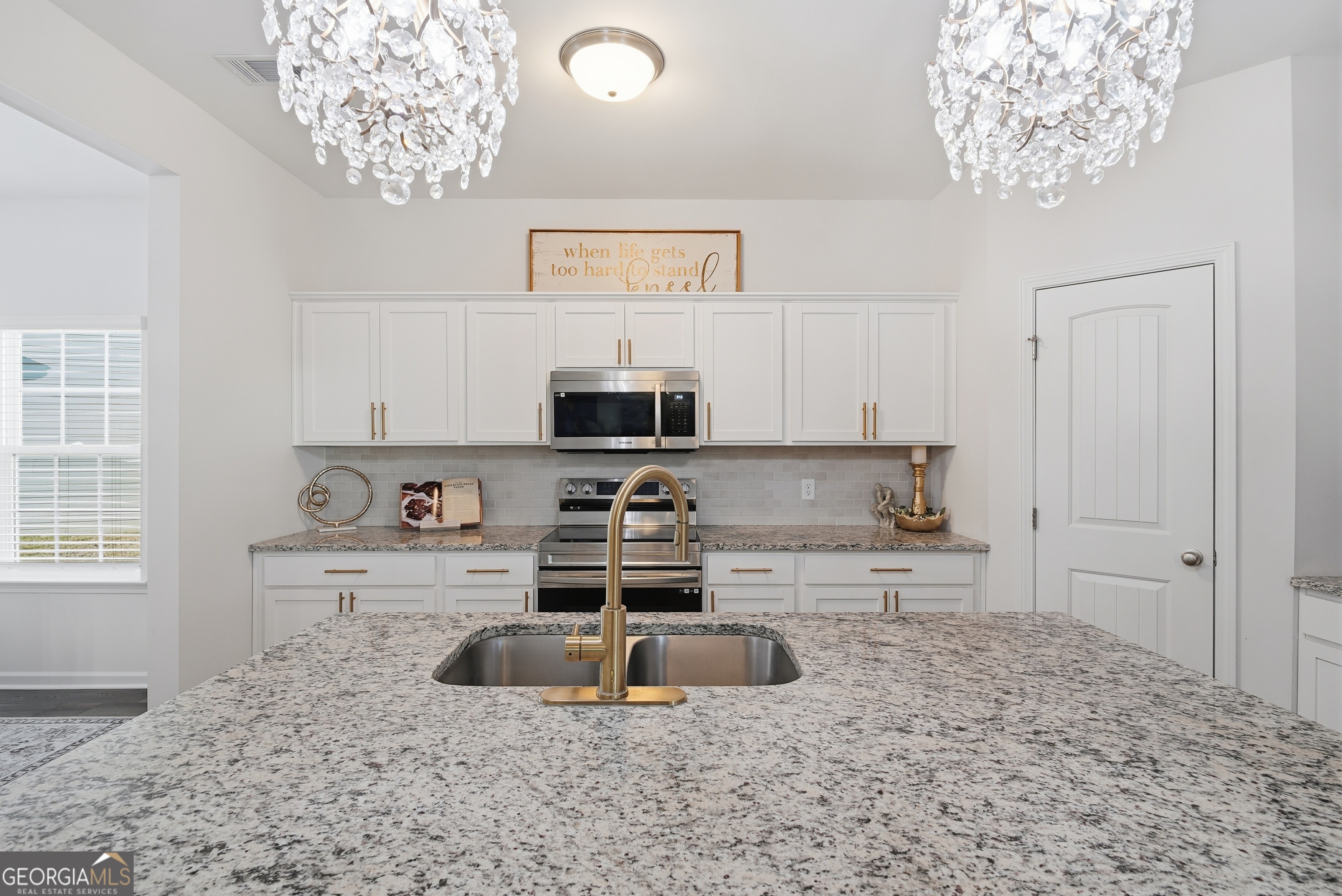 1160 Turpentine Trail Fort Stewart, GA 31313 - Photo 13 of 39 a kitchen with stainless steel appliances granite countertop a sink a stove and a refrigerator