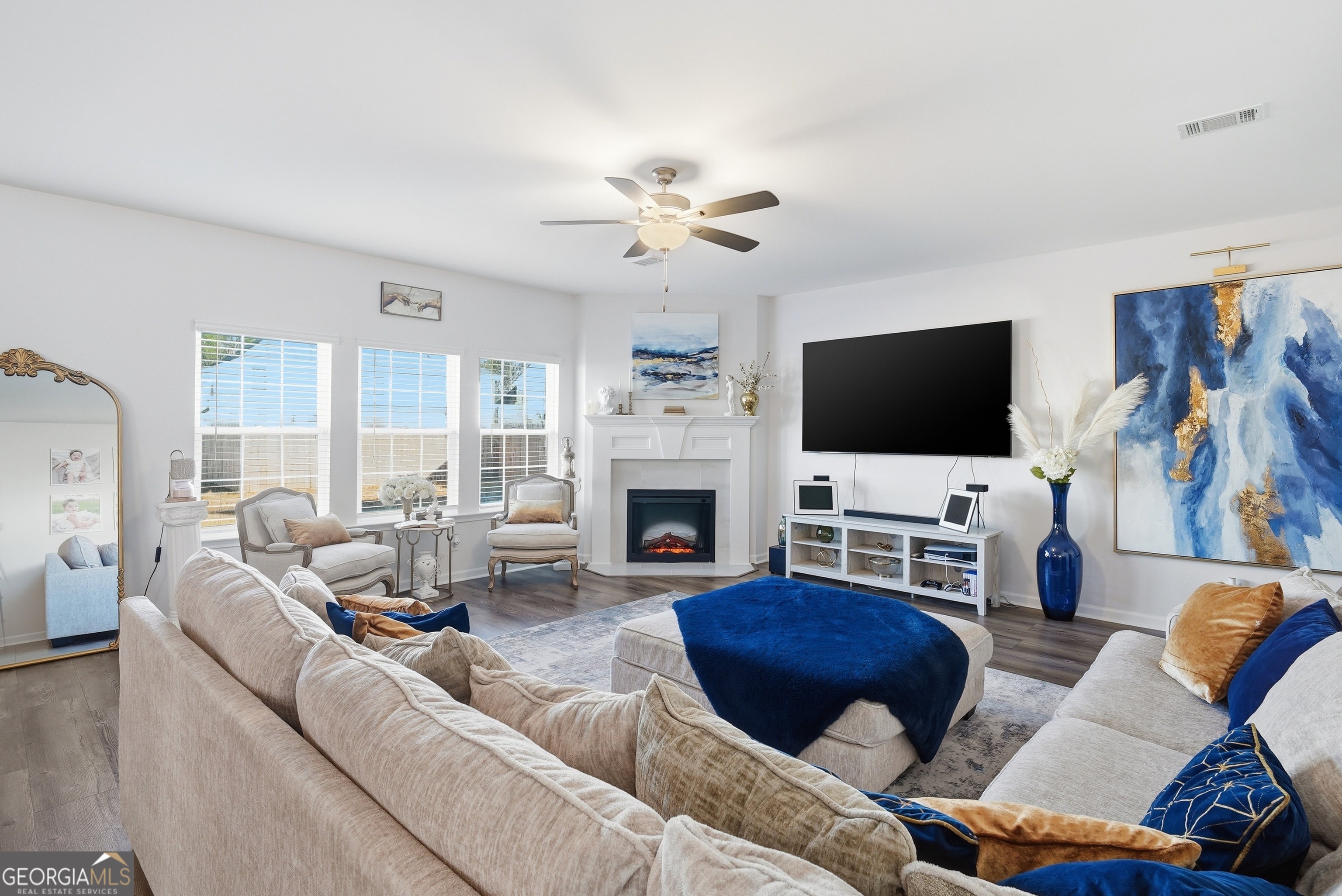 1160 Turpentine Trail Fort Stewart, GA 31313 - Photo 16 of 39 a living room with furniture a flat screen tv and a fireplace