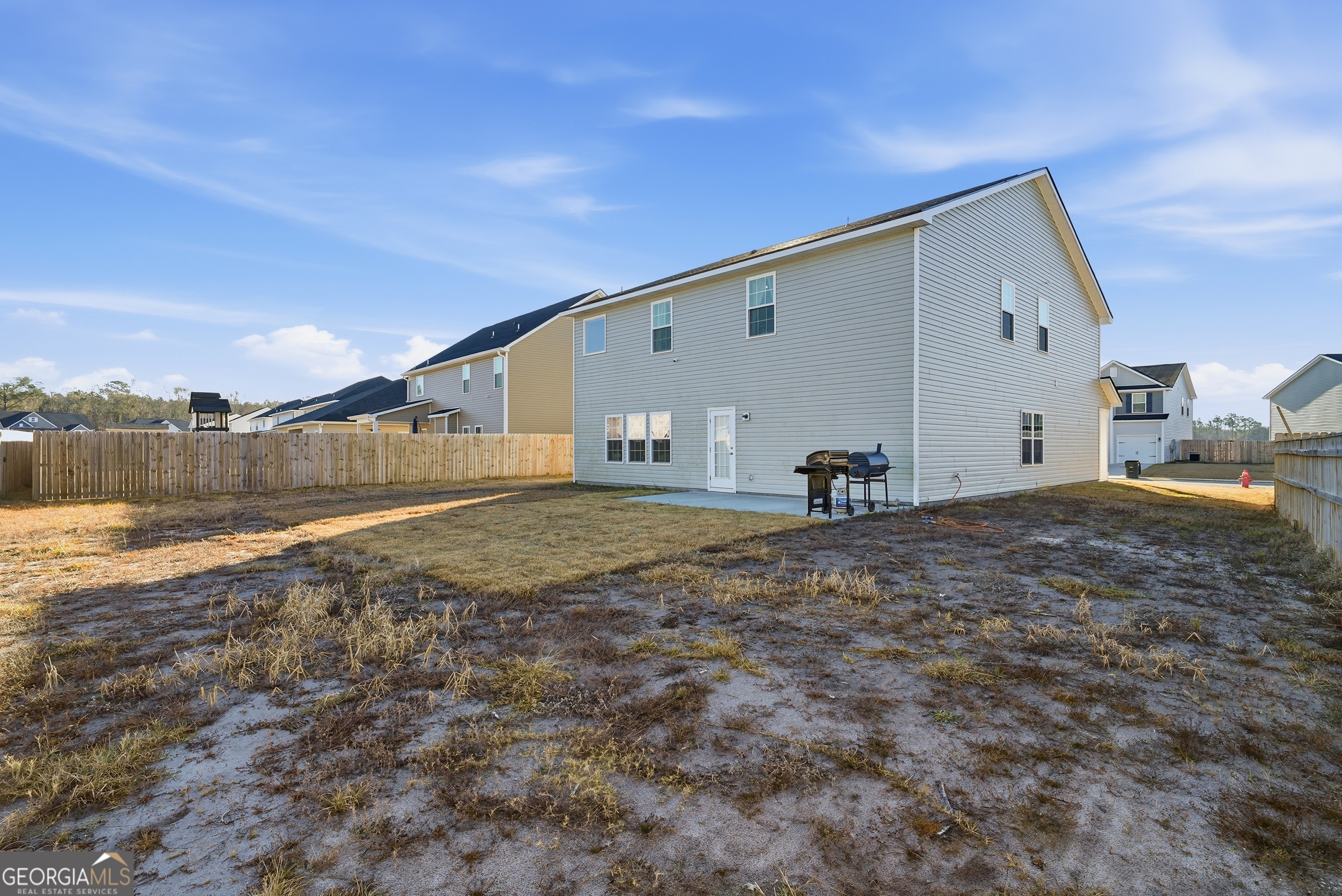 1160 Turpentine Trail Fort Stewart, GA 31313 - Photo 37 of 39 a backyard of a house with table and chairs