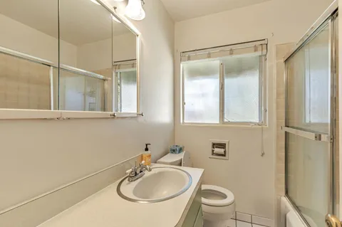 a bathroom with a sink toilet and shower