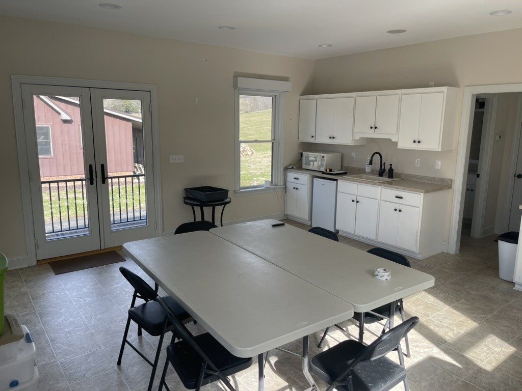 501 Gray Road Lynchburg, TN 37352 - Photo 12 of 44 a large kitchen with sink a refrigerator and white cabinets