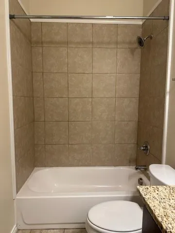 a bathroom with a toilet and a bath tub