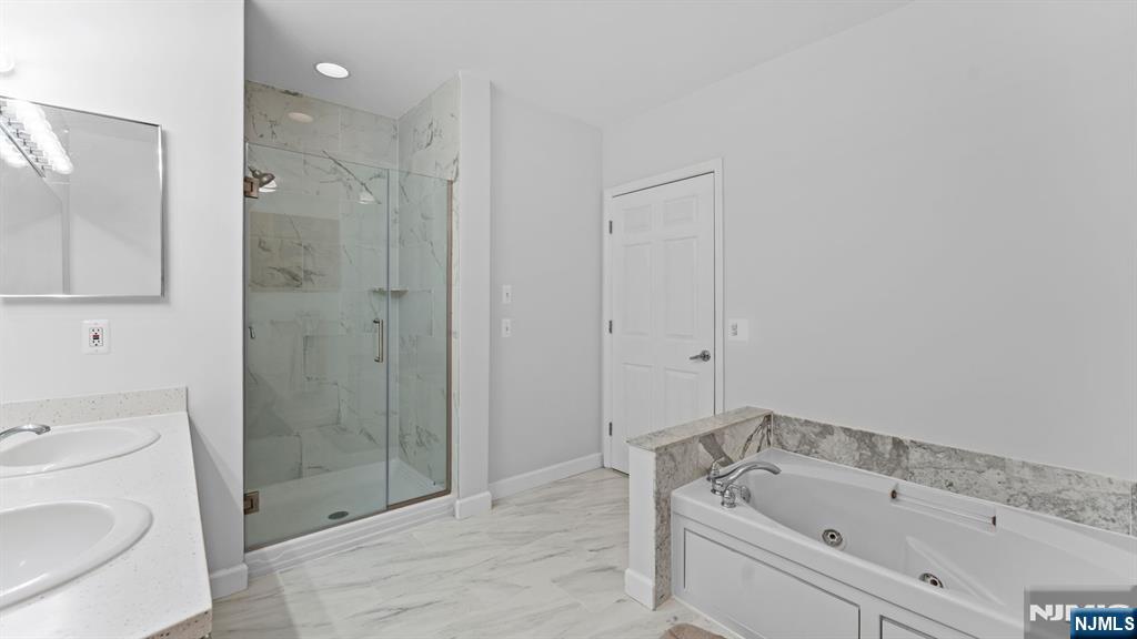 344 The Promenade, Unit 344 Edgewater, NJ 07020 - Photo 28 of 44 a bathroom with a sink a toilet and shower