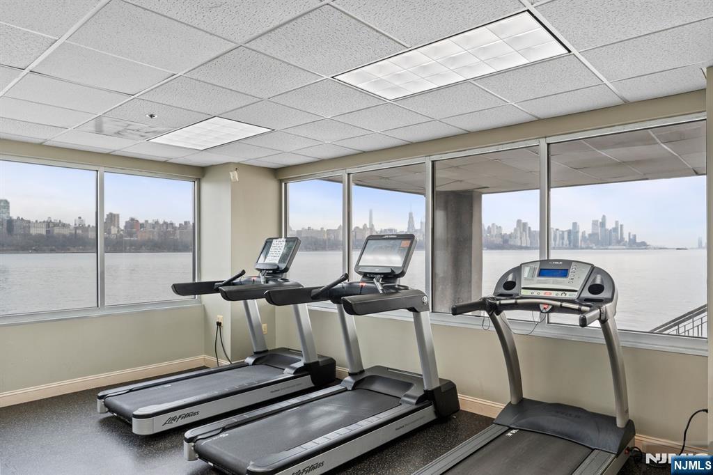 344 The Promenade, Unit 344 Edgewater, NJ 07020 - Photo 37 of 44 a room with gym equipment and large windows