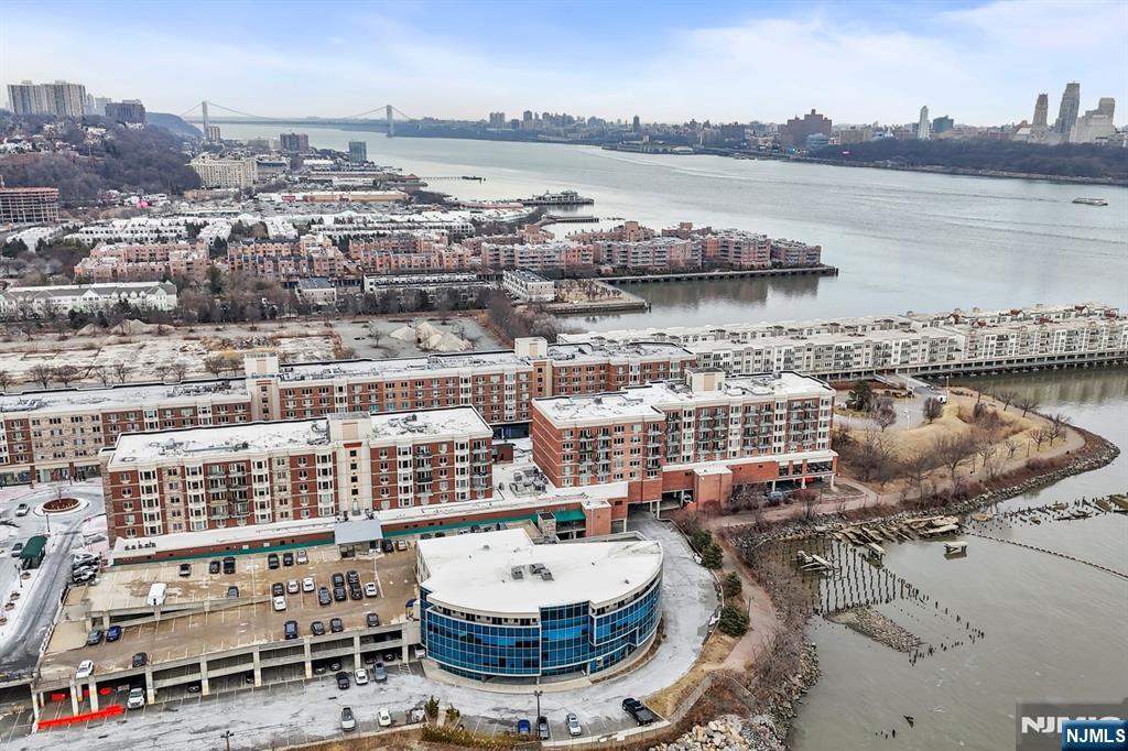344 The Promenade, Unit 344 Edgewater, NJ 07020 - Photo 40 of 44 a view of a lake with tall buildings
