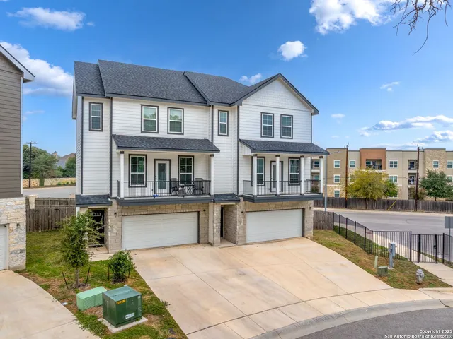 a front view of house along with deck and outdoor seating