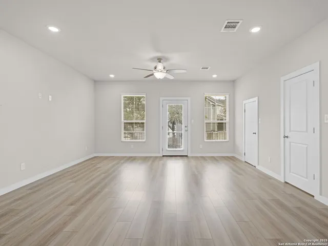 a view of empty room with wooden floor
