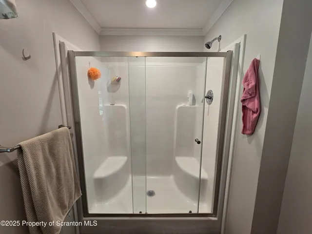 a bathroom with a shower and a sink