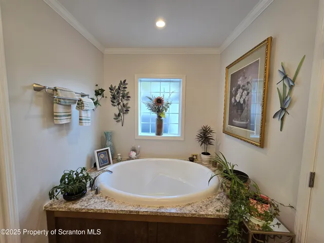 a bed room with a bed furniture and a flat tv screen