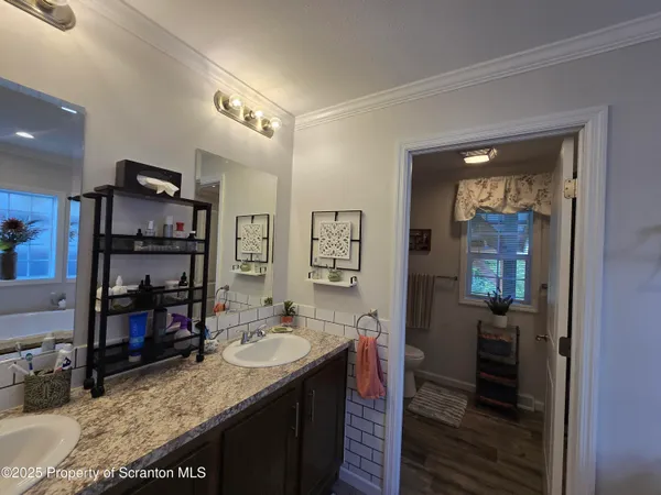 a bath tub sitting next to a white sink