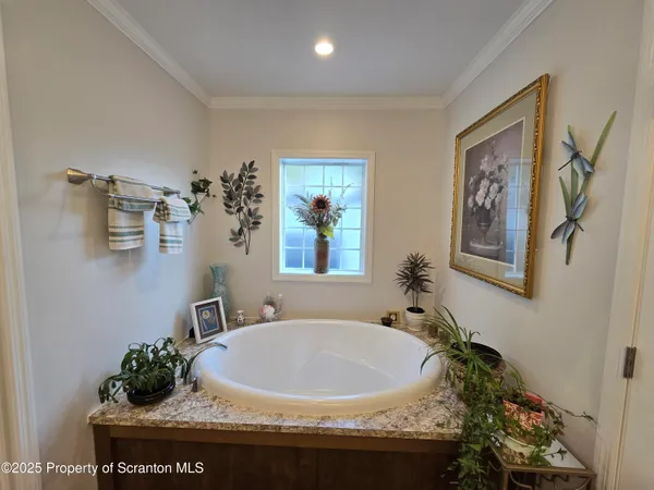 a bed room with a bed furniture and a flat tv screen
