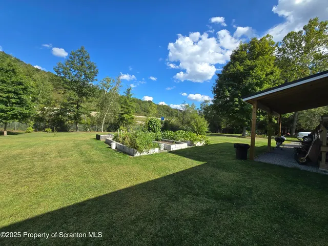 a backyard of a house with yard and outdoor seating