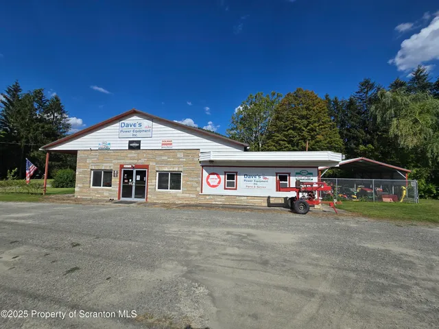 a front view of a house with a yard table and chairs