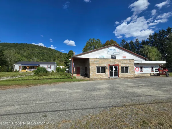 a view of a white house with a street
