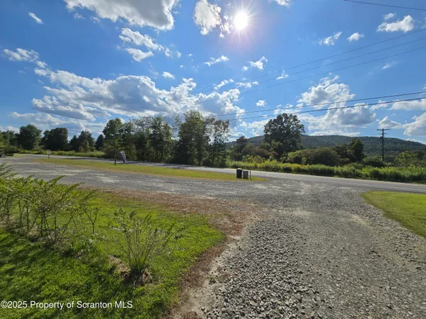 a living room with furniture a flat screen tv and floor to ceiling window
