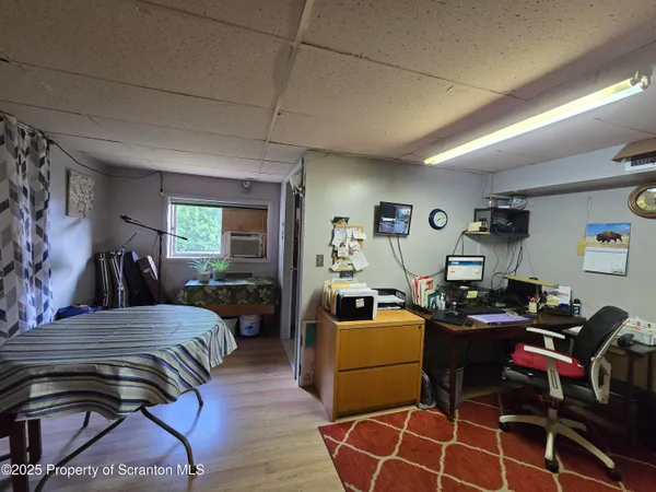 a work room with furniture and wooden floor