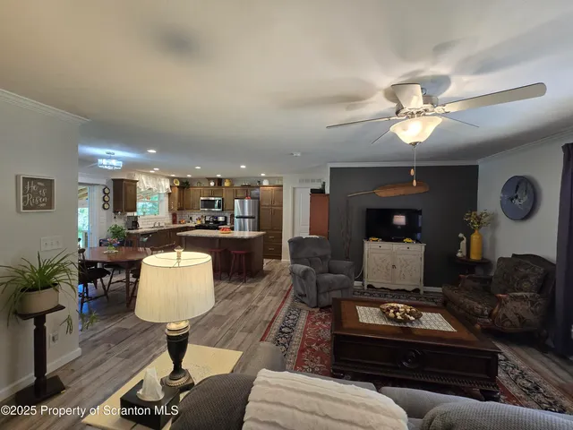 a living room with furniture a chandelier and a table