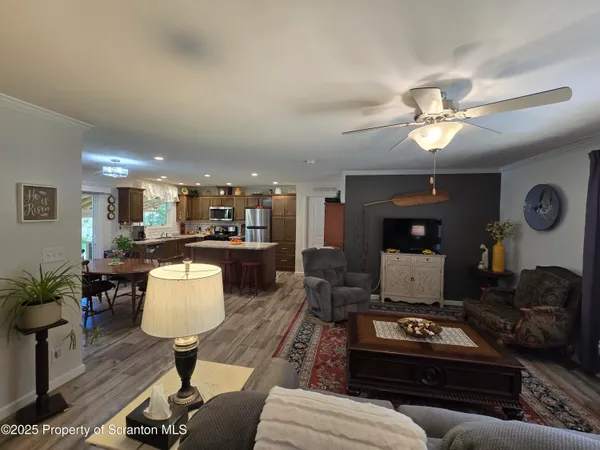 a living room with furniture a chandelier and a table