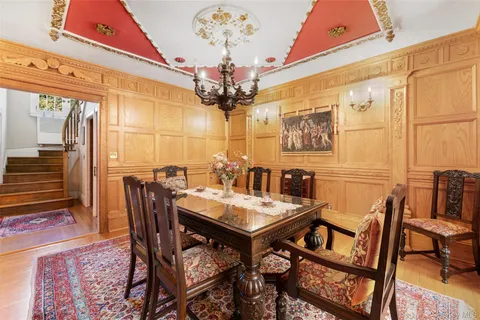 a view of a dining room with furniture and a chandelier