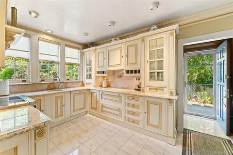 a kitchen with stainless steel appliances granite countertop a stove and a sink