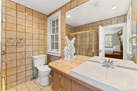 a bedroom with a bed a dresser and windows