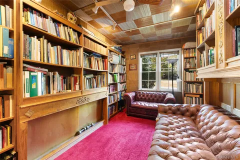 a bedroom with furniture and a book shelf