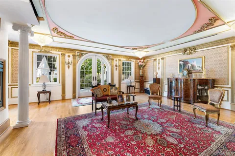 a living room with furniture a rug and a large window