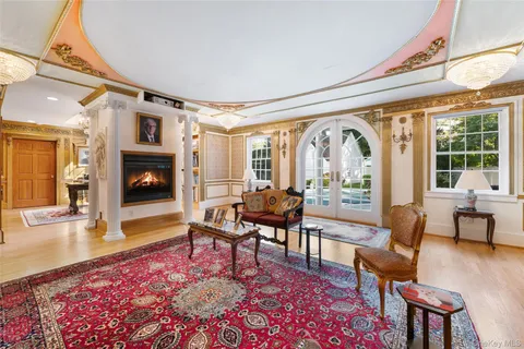 a living room with furniture fireplace and a large window