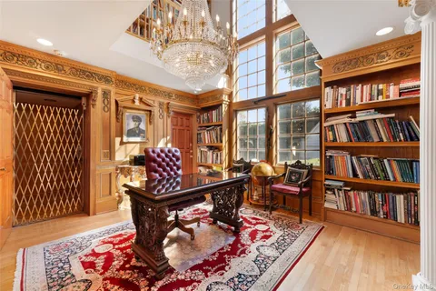 a living room with furniture and a book shelf