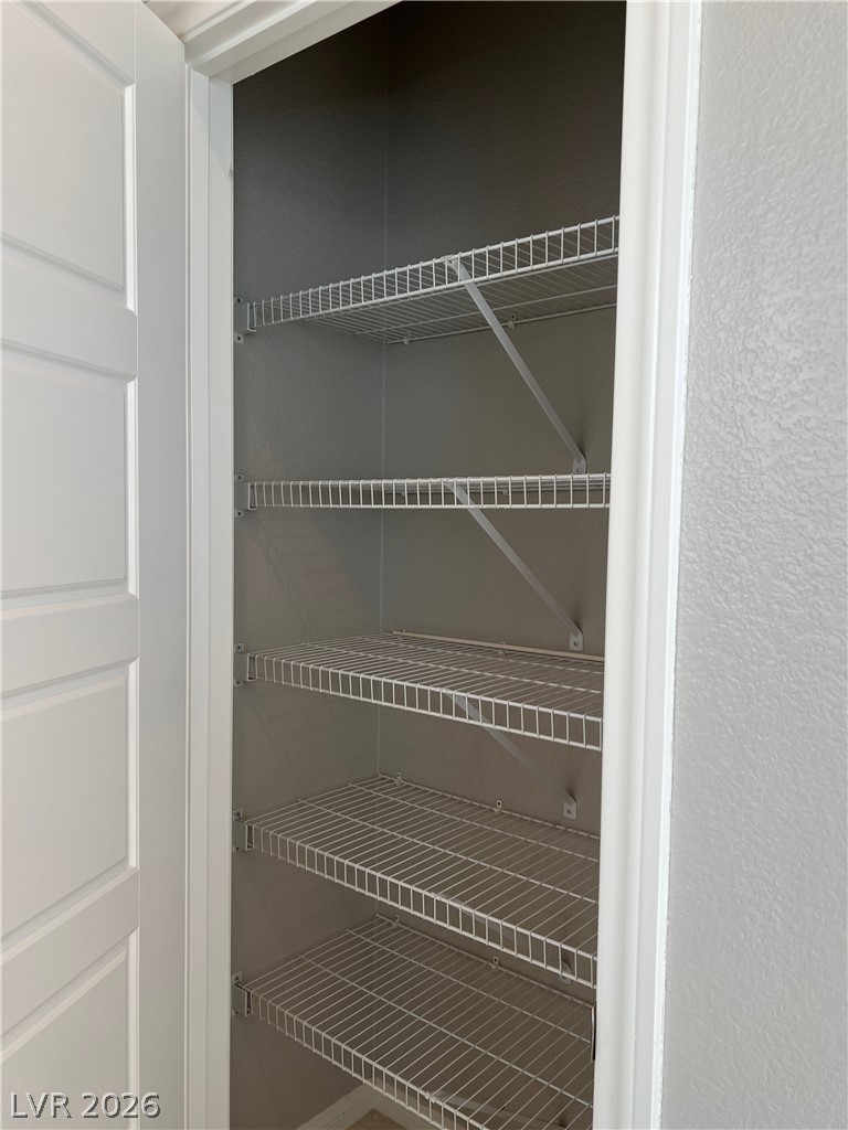 5981 Honeysuckle Ridge Street Las Vegas, NV 89148 - Photo 6 of 29 Ample wire shelving provides streamlined storage solutions within this functional pantry.