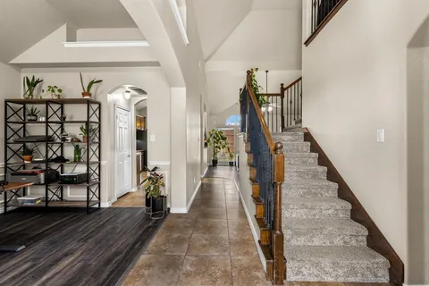 a bedroom with bed tv and window