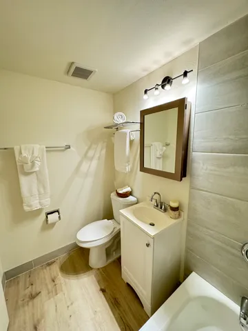 a bathroom with a sink toilet and shower