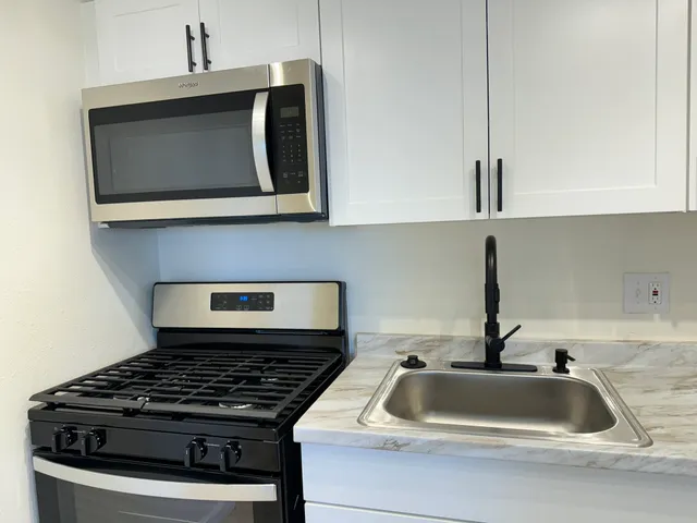 a kitchen with a stove and a sink