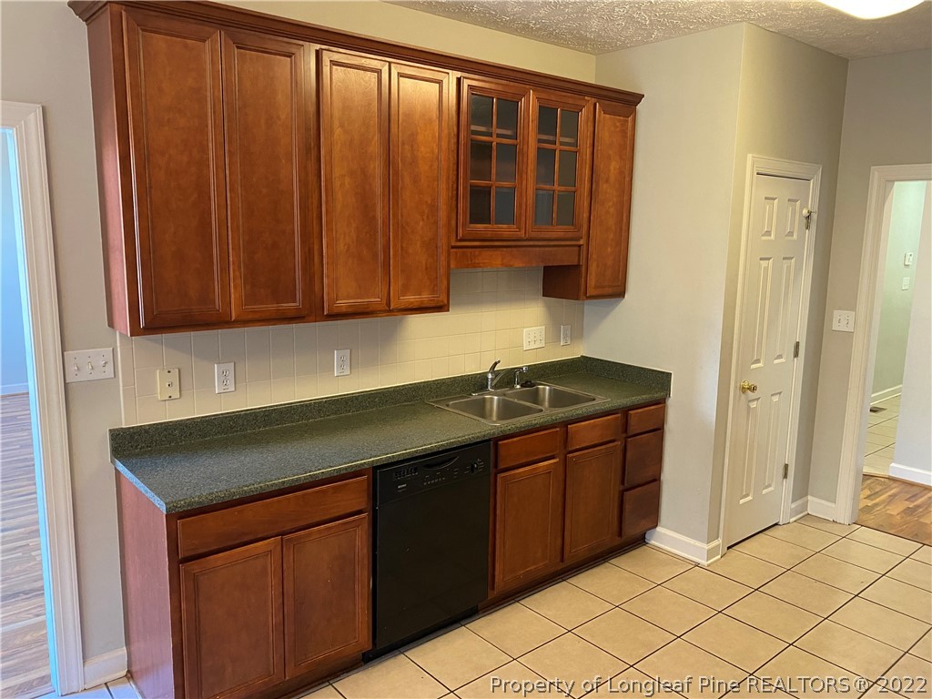 3532 Talus Road Fayetteville, NC 28306 - Photo 17 of 34 a kitchen with stainless steel appliances granite countertop a sink and cabinets