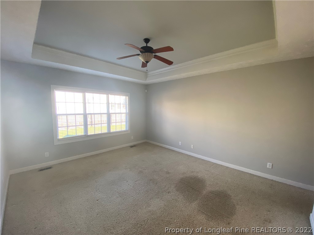 3532 Talus Road Fayetteville, NC 28306 - Photo 20 of 34 an empty room with a ceiling fan and windows